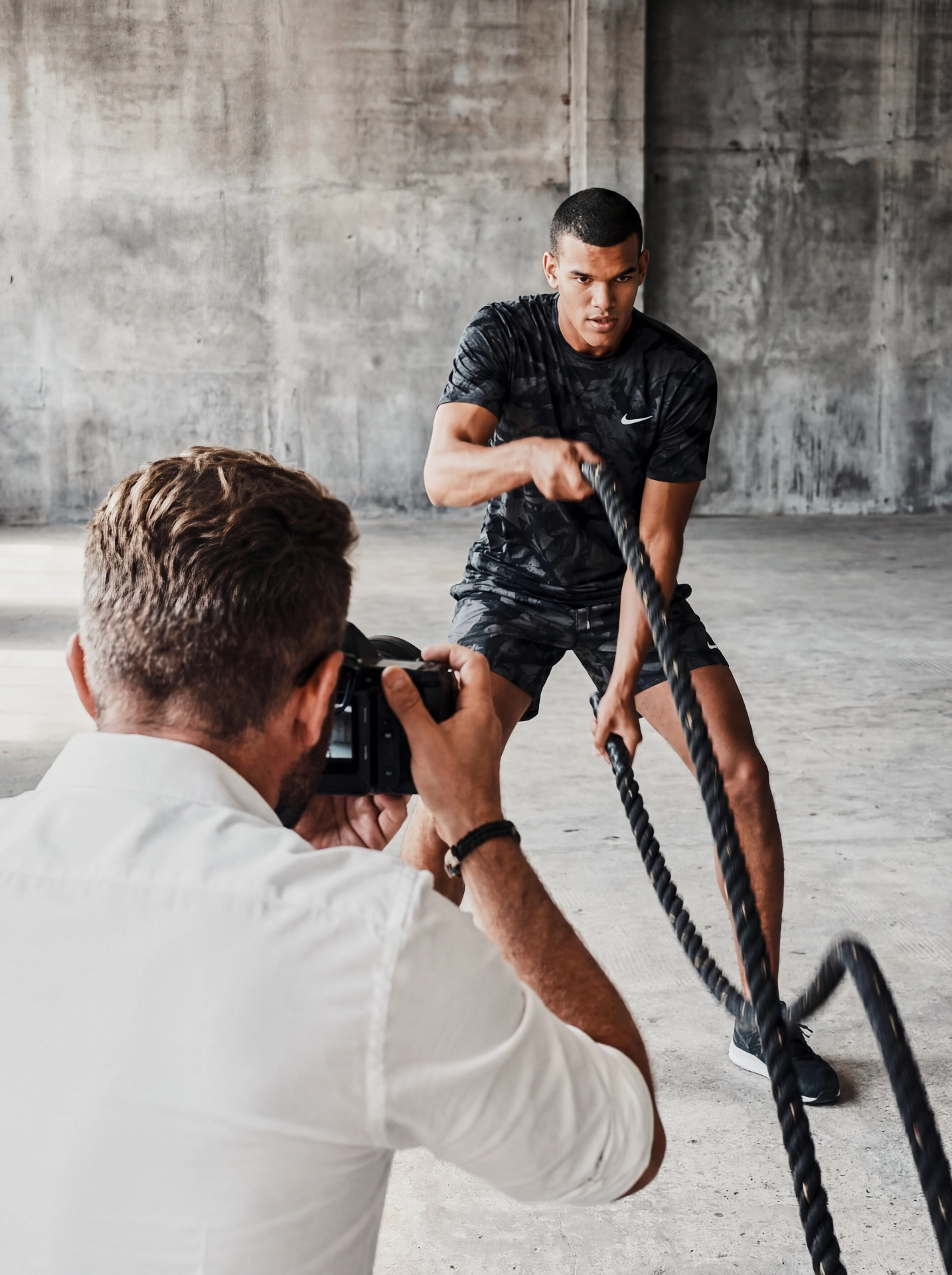 Behind the scenes photograph showing a professional photographer working during a photoshoot