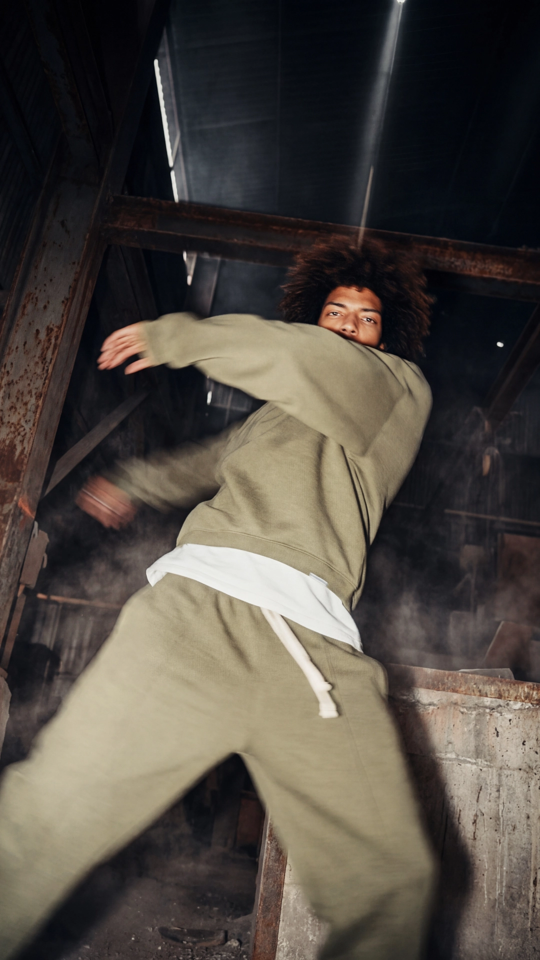 Model wearing high fashion styled in a lost industrial space